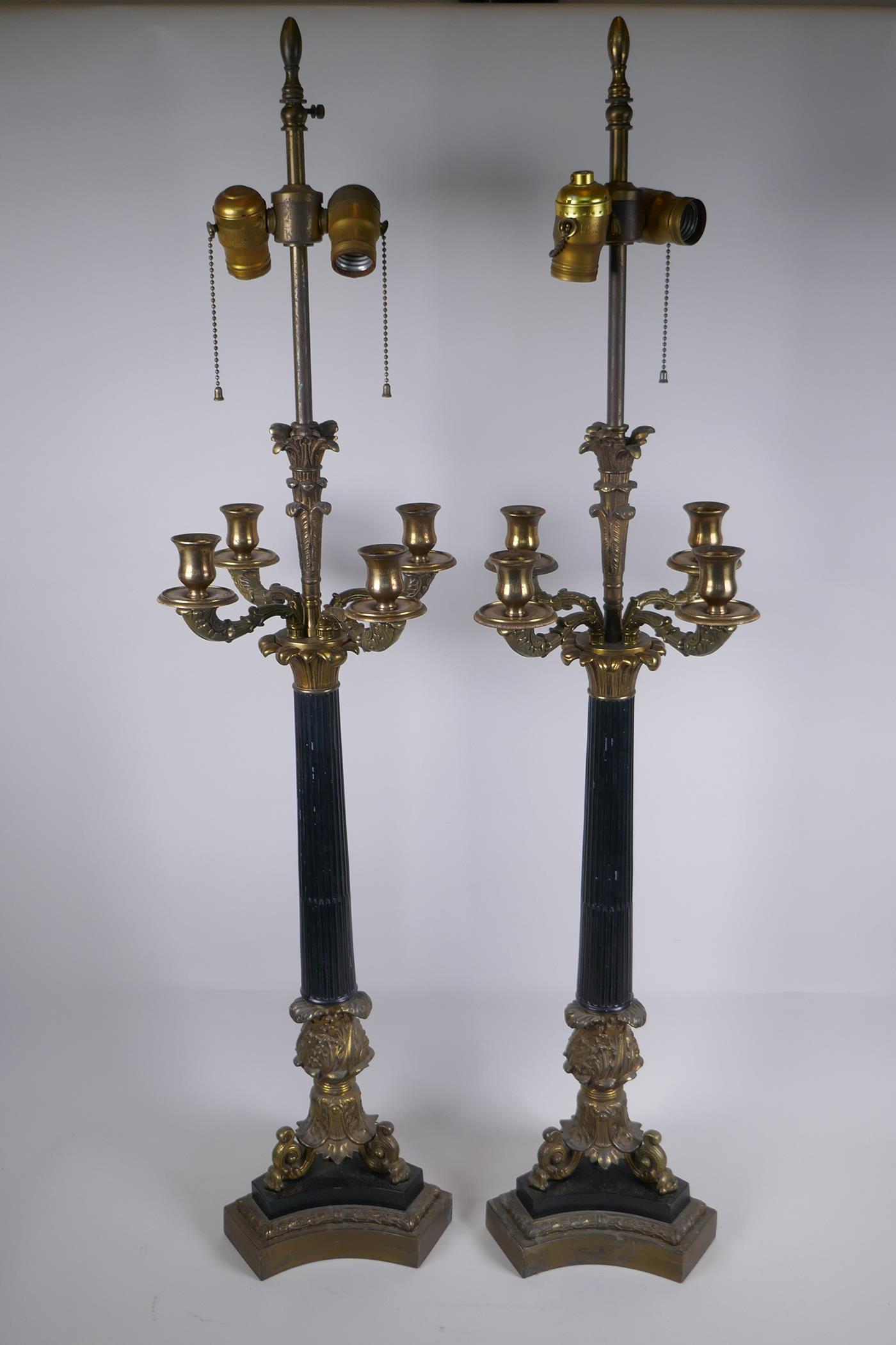 A pair of Empire style bronze and ormolu Corinthian four branch table lamps, 98cm high