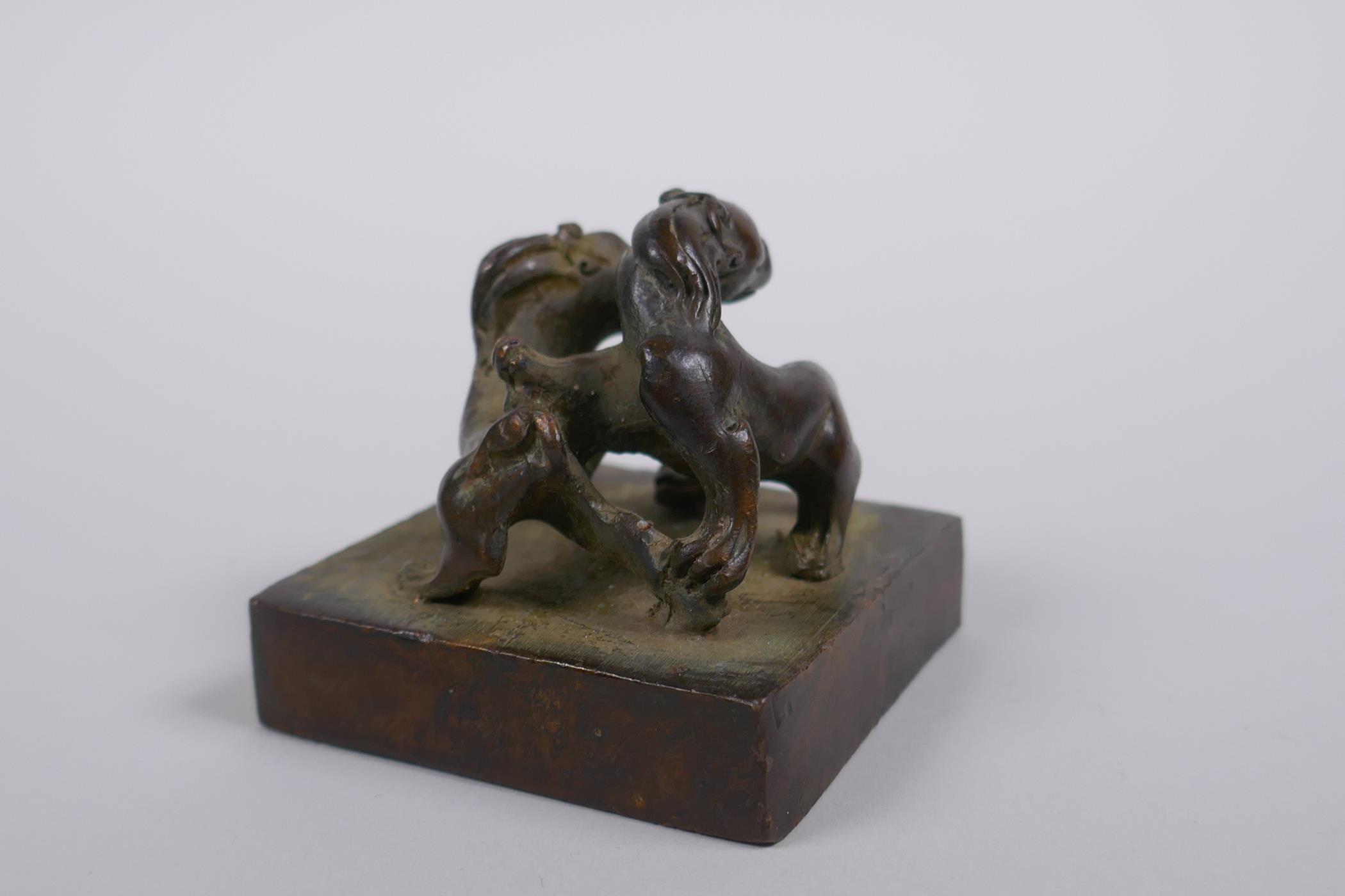 A Chinese bronze seal decorated with two entwined kylin, 5 x 5cm - Image 3 of 4