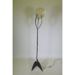 A contemporary wrought iron and glass standard lamp,ÿ