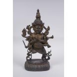 A Tibetan bronze of a wrathful deity with the remnants of gilt patina, impressed double vajra mark