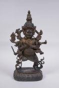 A Tibetan bronze of a wrathful deity with the remnants of gilt patina, impressed double vajra mark