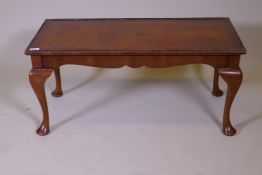 A Queen Anne style coffee table with figured walnut top and inset glass, labelled H. Shaw, London,