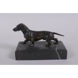An antique bronze figure of a Dachshund, on a marble base, 10cm long