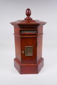 A hexagonal fruitwood table table post box with brass letter slot, 46cm high