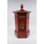 A hexagonal fruitwood table table post box with brass letter slot, 46cm high