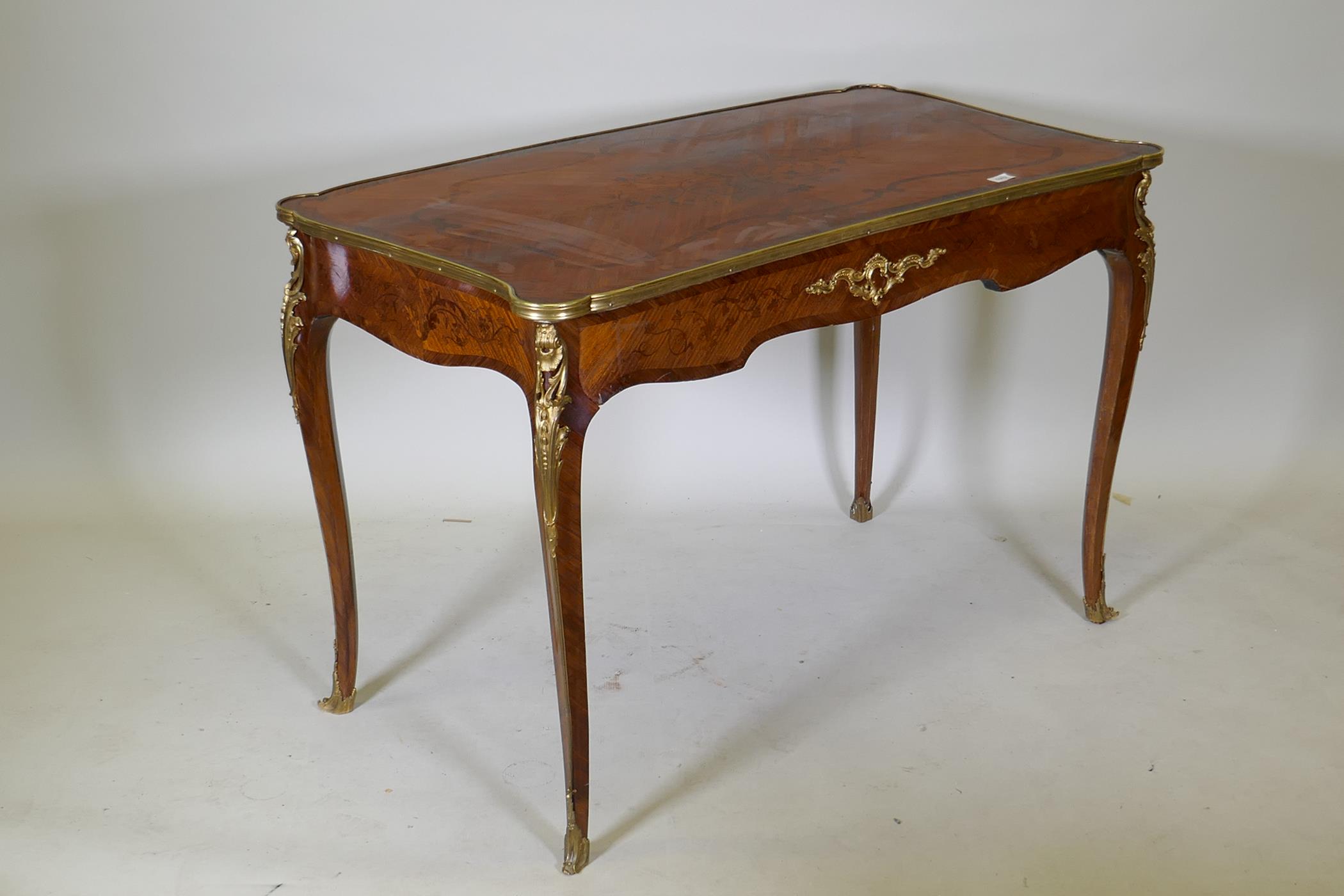 A French marquetry inlaid bureau plat, with shaped top, single drawer and ormolu mounts, bears label - Image 5 of 6