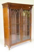 A Regency mahogany bookcase top with reeded columns flanking two gothic astragal glazed doors,