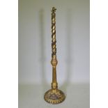 An antique gilt composition standard lamp with moulded floral and mask decoration, 150cm high