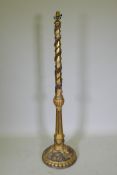 An antique gilt composition standard lamp with moulded floral and mask decoration, 150cm high