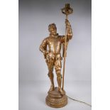 A gilt spelter figural lamp in the form of a Renaissance gentleman, 86cm high