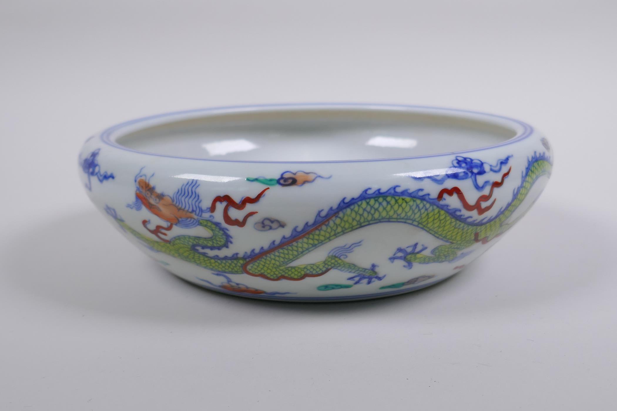 A Chinese Doucai porcelain dish with rolled rim, decorated with dragons, Chenghua 6 character mark