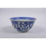 A Chinese blue and white porcelain rice bowl with script and lotus flower decoration, 13cm diameter