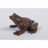 A Japanese style bronze okimono toad, mark to base, 4cm long