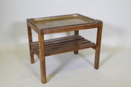 A brass and oak tray table with a slatted undertier, 64 x 49cm, 52cm high