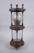 An antique silver plate and turned wood hour glass sand timer, 37cm high x 13cm diameter