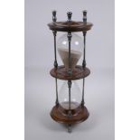 An antique silver plate and turned wood hour glass sand timer, 37cm high x 13cm diameter