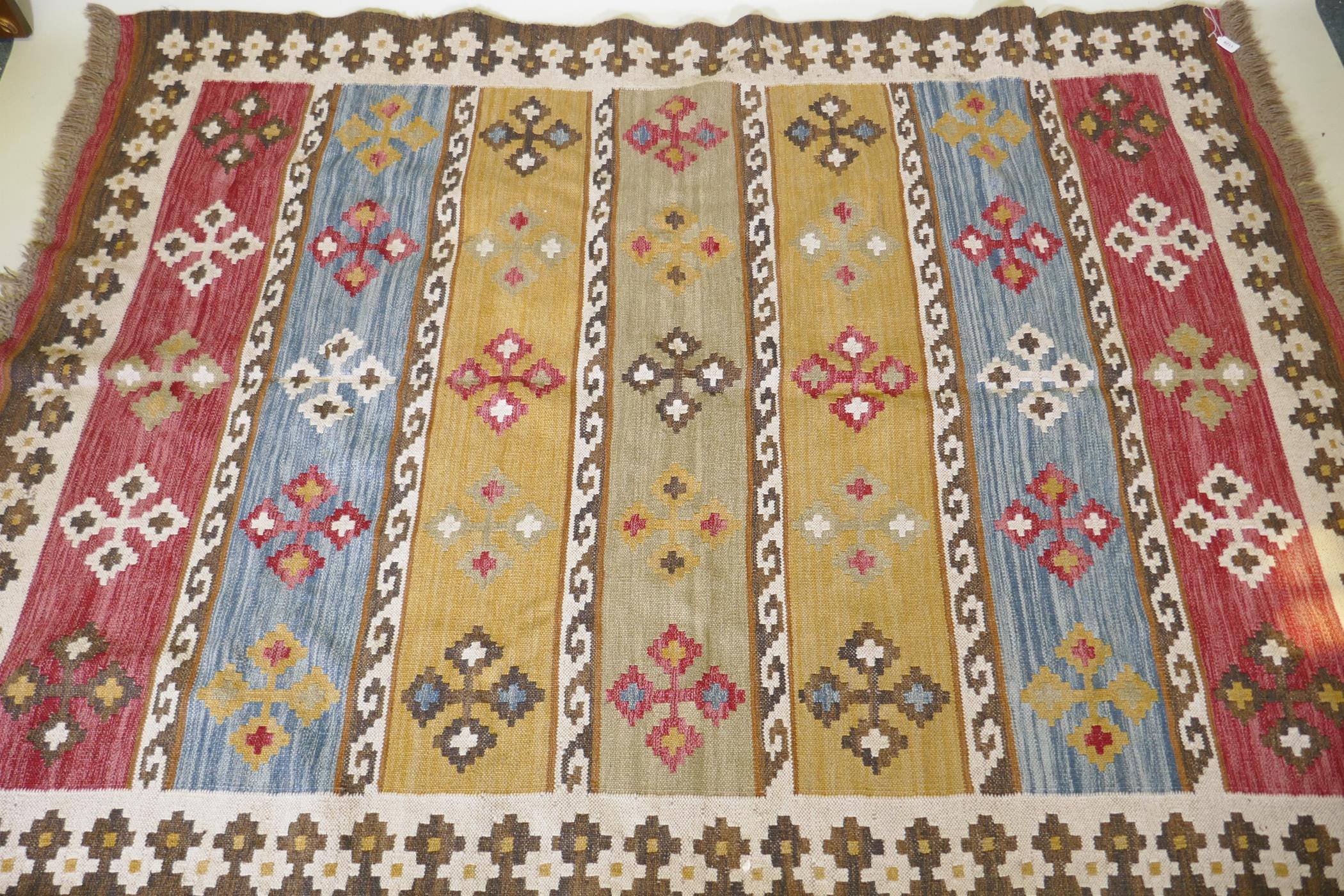 A woven wool kilim rug with geometric designs, 170 x 240cm