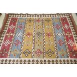 A woven wool kilim rug with geometric designs, 170 x 240cm