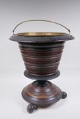 A Dutch coopered wood and brass lined peat bucket/champagne cooler, raised on ball feet, 42cm