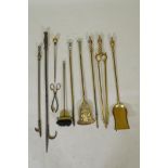 A set of three brass Empire style fire irons and a quantity of other fire irons including a