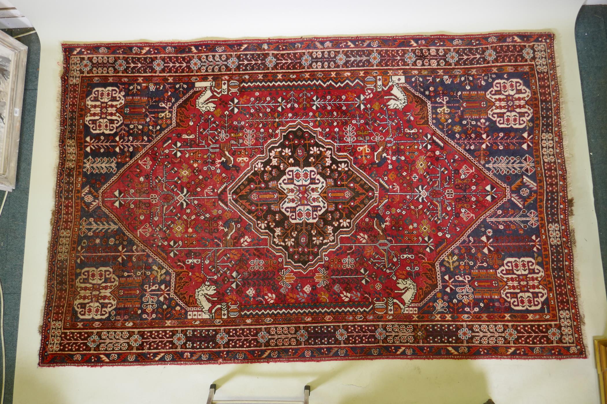 A hand woven red ground Persian carpet decorated with a geometric medallion, birds and camels, 158 x - Image 2 of 6