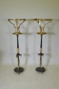 A pair of C19th Empire style iron and ormolu torcheres, adapted, 124cm high, 37cm diameter