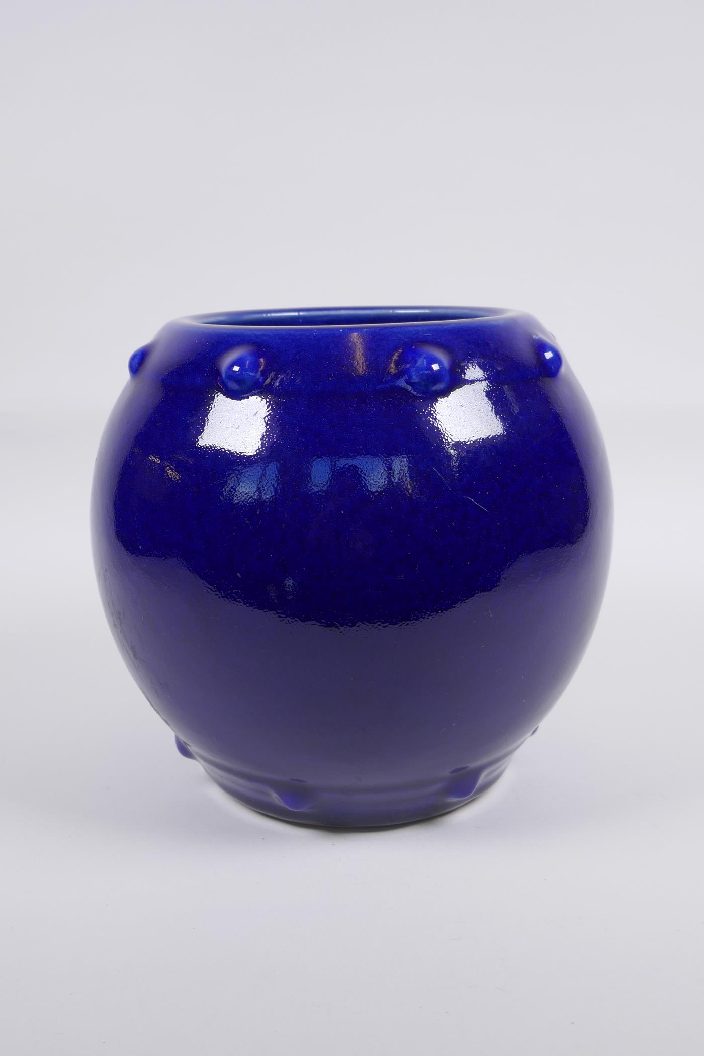 A Chinese blue glazed porcelain barrel shaped vase, KangXi 6 character mark to base, 19cm high, 22cm