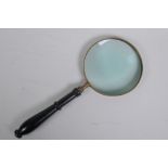 A brass and ebonised wood handled magnifying glass, 37cm long