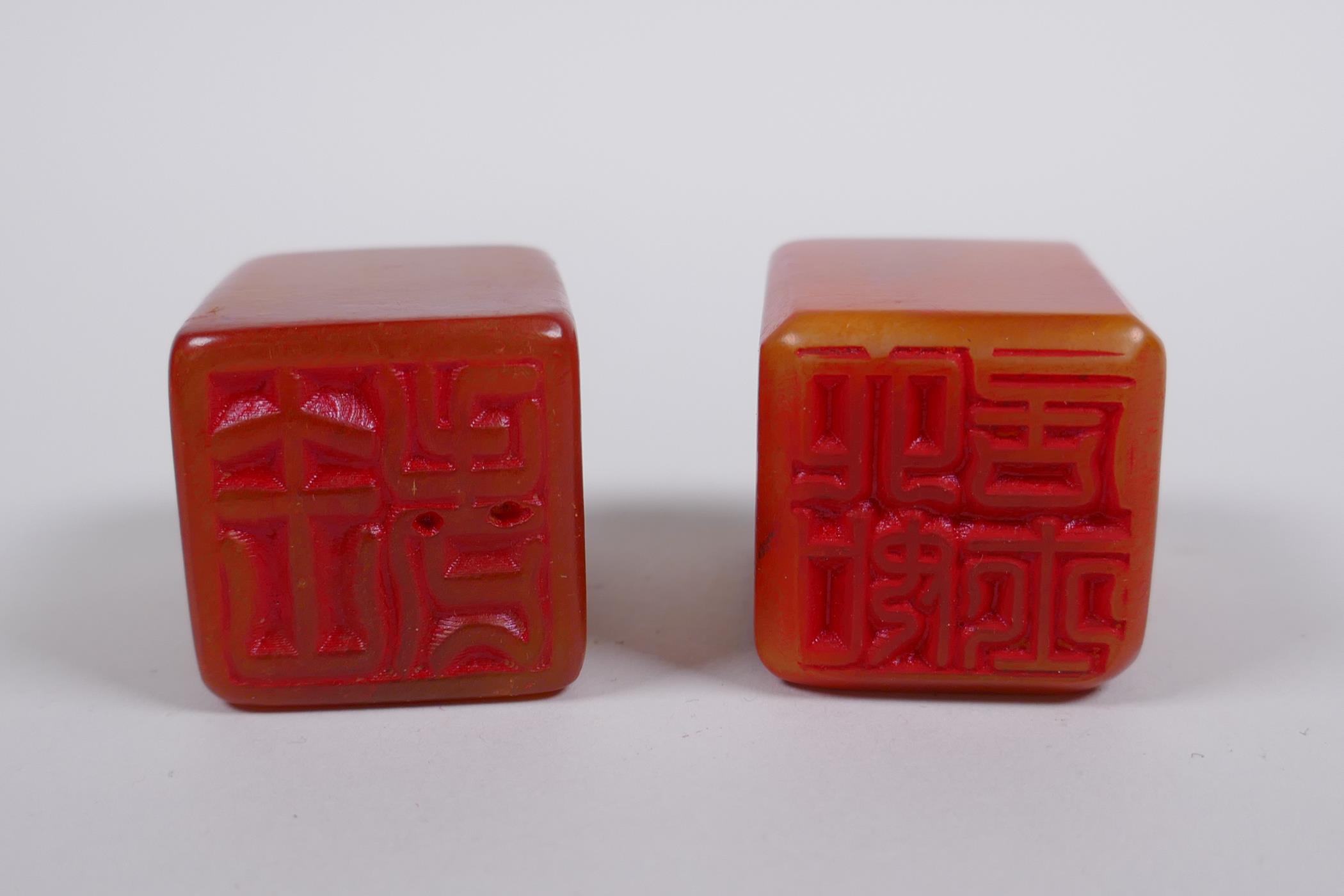 A pair of Chinese amber soapstone seals with dragon mask and lotus pad decoration, 3 x 3cm, 4cm high - Image 3 of 3