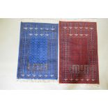 An oriental hand woven wool prayer rug with geometric designs on a red field and another in blue,