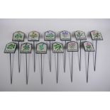 A set of twelve painted cast iron herb markers, 27 cm long