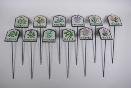 A set of twelve painted cast iron herb markers, 27 cm long