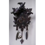 An antique carved Black Forest cuckoo clock, bellows intact, 36 x 56cm