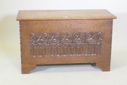 A carved oak coffer on bracket feet, one detached, 98 x 44cm, 58cm high