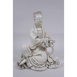 A Chinese blanc de chine porcelain figure of Quan Yin, impressed seal mark to the reverse, 25cm high
