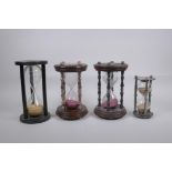 A pair of vintage silver plated and turned wood hourglass sand timers with white metal decoration to