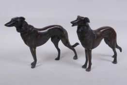 A pair of cast bronze hounds, 25cm long
