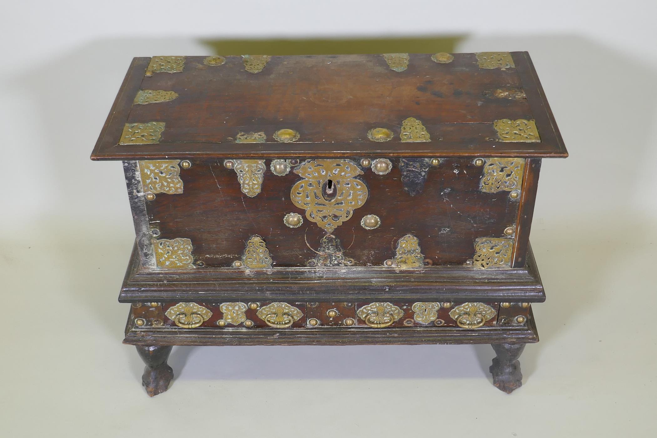 An C18th Dutch colonial teak chest with brass mounts, lift up top and two drawers, raised on claw - Image 2 of 8