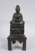 A Chinese bronze figure of Buddha seated on a throne, character inscription to legs, 24cm high