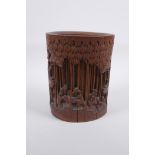A late C19th/early C20th Chinese carved bamboo brush pot decorated with scholars in a bamboo forest,