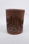 A late C19th/early C20th Chinese carved bamboo brush pot decorated with scholars in a bamboo forest,