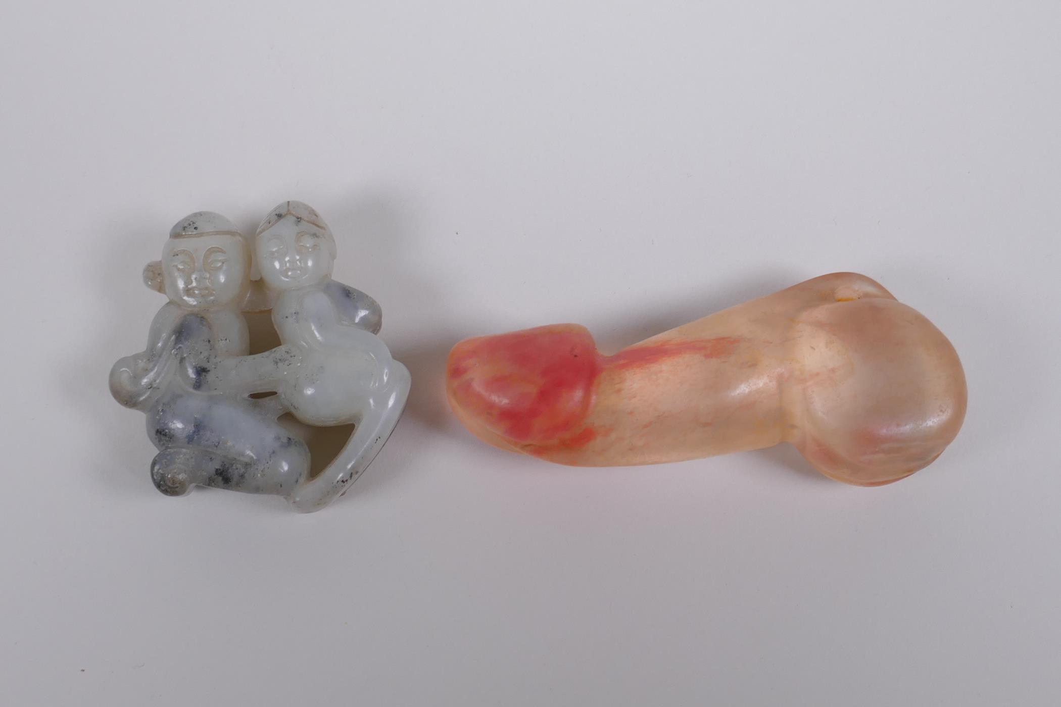 A Chinese carved grey hardstone pendant of erotic form, and a carved crystal phallic pendant, 8cm