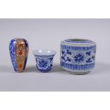 A Chinese blue and white porcelain cylinder pot, a miniature porcelain tea bowl, and a miniature