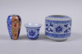 A Chinese blue and white porcelain cylinder pot, a miniature porcelain tea bowl, and a miniature