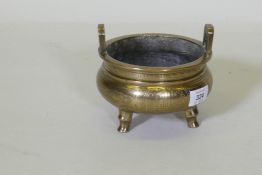 A Chinese polished brass censer with engraved dragon and phoenix decoration, seal mark to base, 16cm