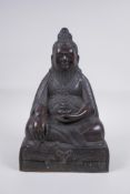 A Sino Tibetan bronze figure of a bearded deity seated in meditation, 29cm high