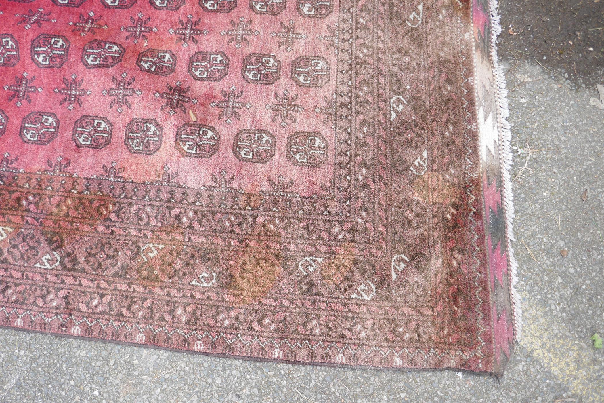 A hand woven wool Bokhara carpet, faded one end, 200 x 300cm - Image 6 of 7