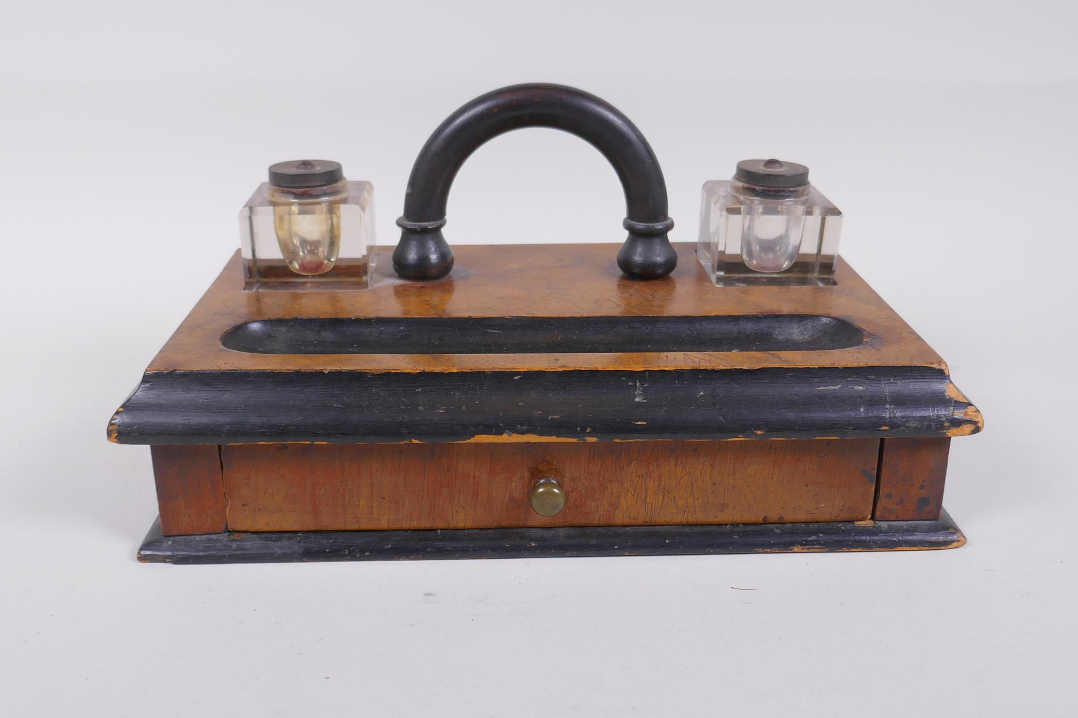 An antique ebonised walnut desk set with twin glass ink wells and a single drawer, 28 x 16cm