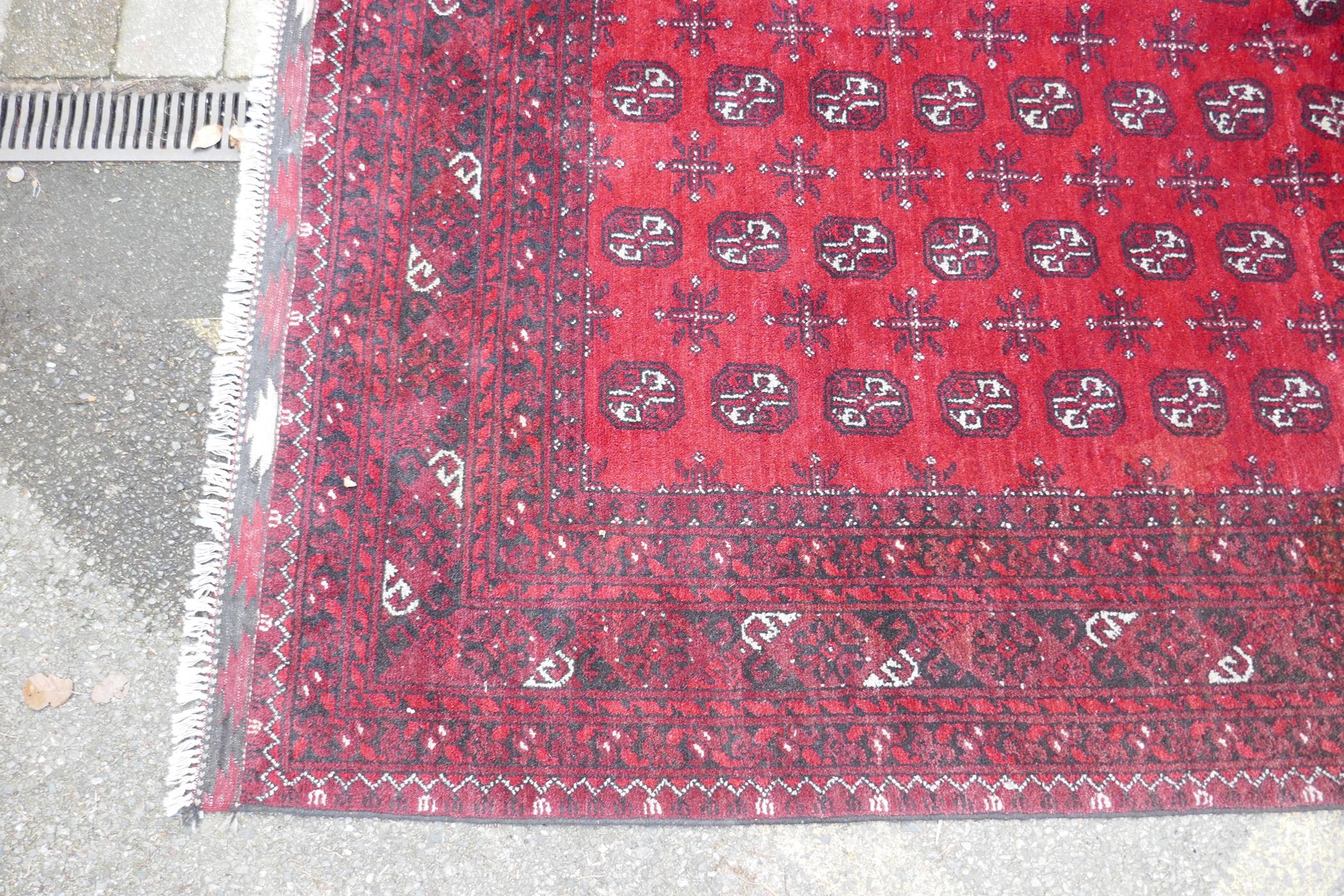 A hand woven wool Bokhara carpet, faded one end, 200 x 300cm - Image 4 of 7