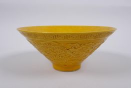 A Chinese yellow ground porcelain bowl of conical form with raised twin dragon decoration, impressed